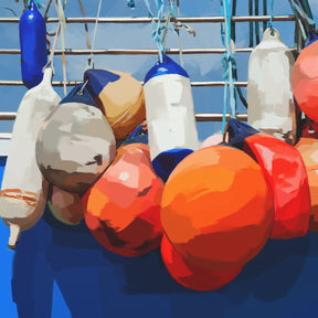 Colorful fishing buoys hanging on a boat with a blue background