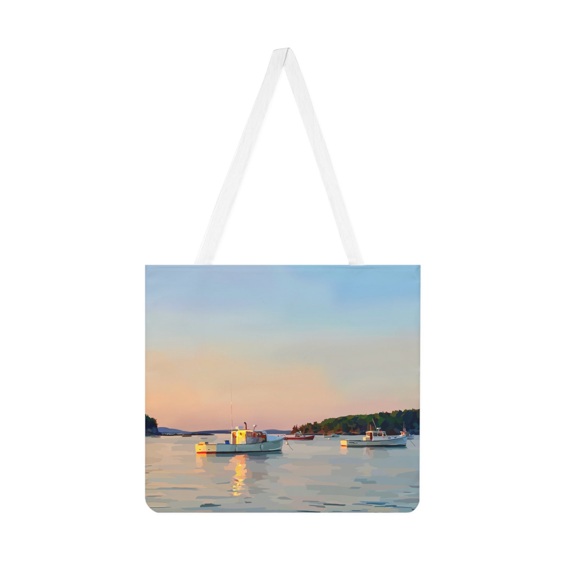 Tote bag with a scenic design of boats on a lake at sunset.