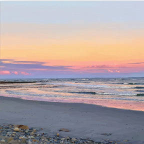 Beach scene with a colorful sunset sky.