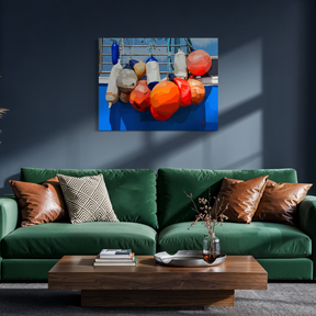 Living room with a green sofa, wooden coffee table, and colorful painting of buoys on the wall.