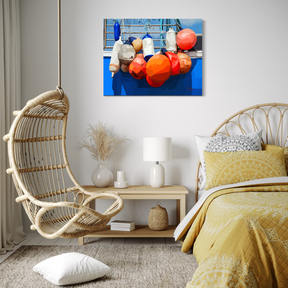 Modern bedroom with a hanging chair, bed, and colorful buoys on the wall.