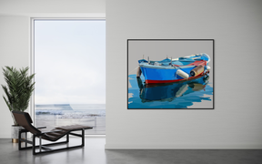 Framed photograph of a blue and red boat on water in a modern interior setting.