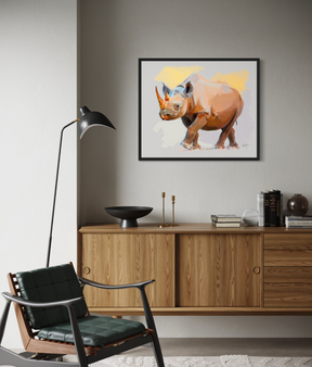 Framed sketch-style rhinoceros in vivid orange, ochre, and purple tones, standing against a soft gray background with yellow accents.